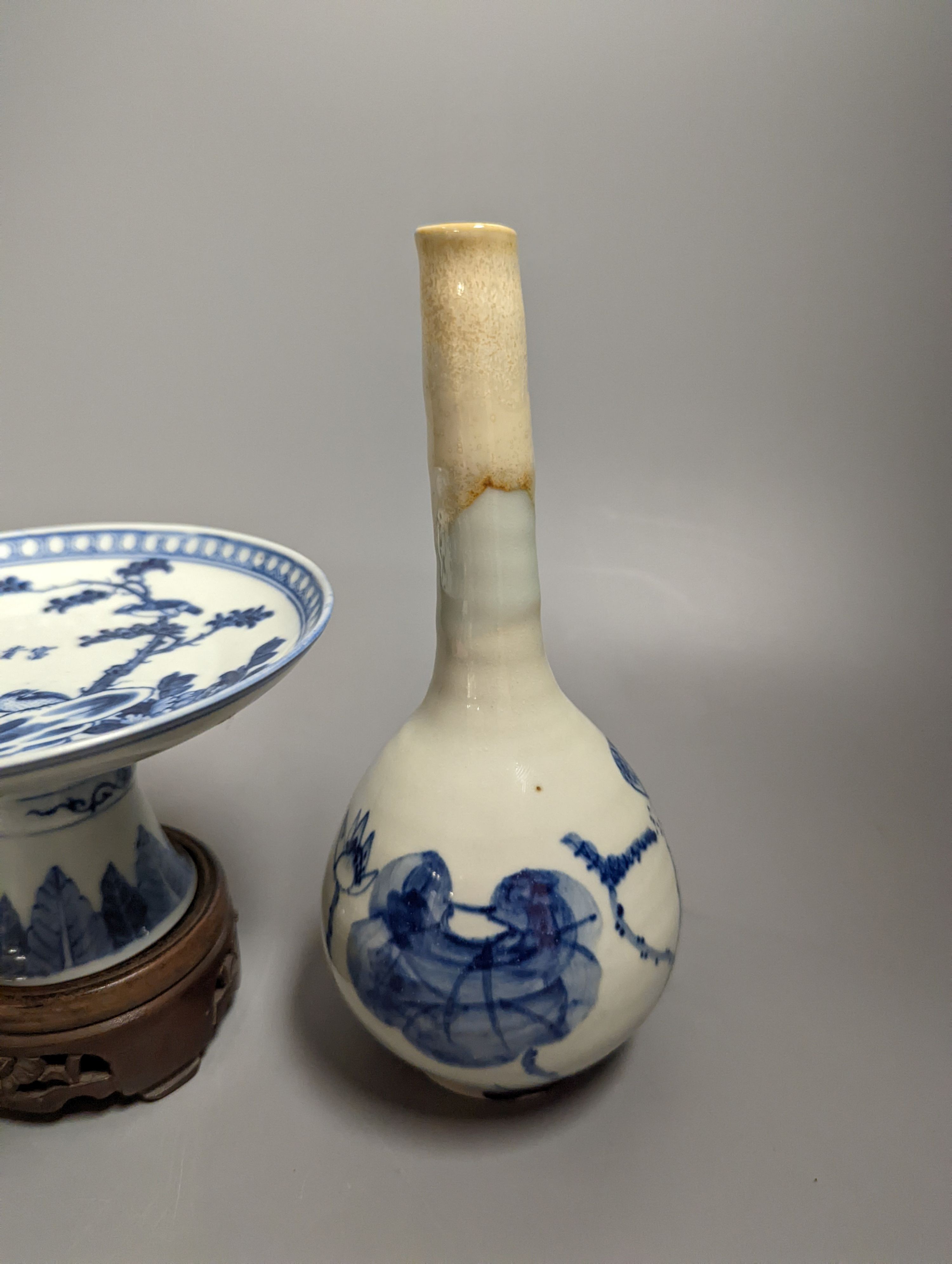 A 19th century Chinese blue and white stem dish, 14cm diameter and a Japanese or Korean art pottery bottle vase, 19cm (2)